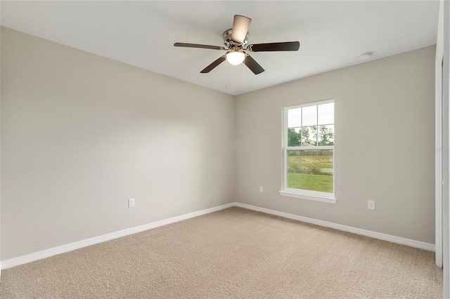 spare room with ceiling fan and carpet floors