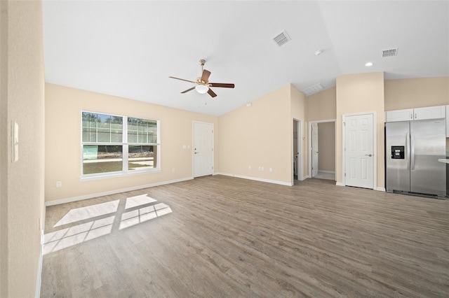 unfurnished living room featuring ceiling fan, light hardwood / wood-style floors, and lofted ceiling