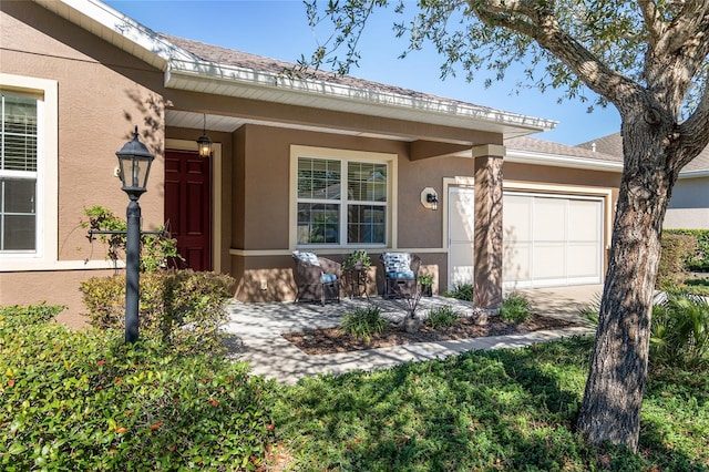 doorway to property with a garage