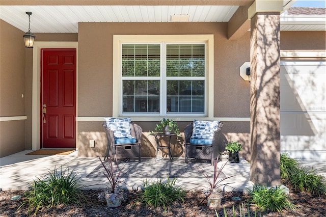 view of exterior entry with covered porch