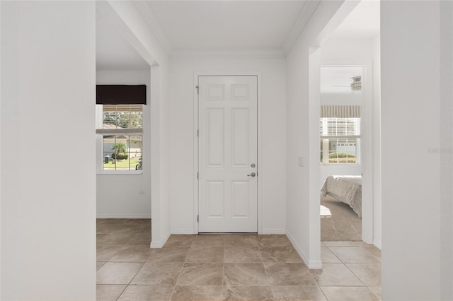 foyer entrance featuring crown molding