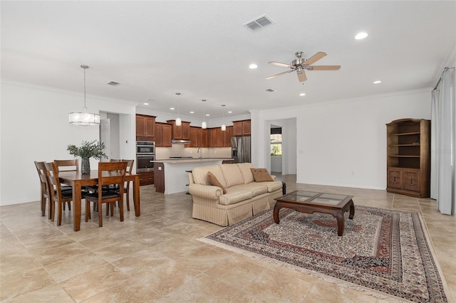 living room with ceiling fan with notable chandelier, crown molding, and sink