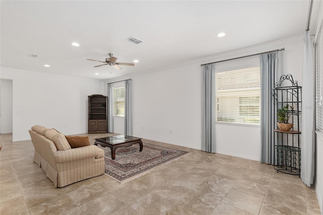 living room with plenty of natural light and crown molding