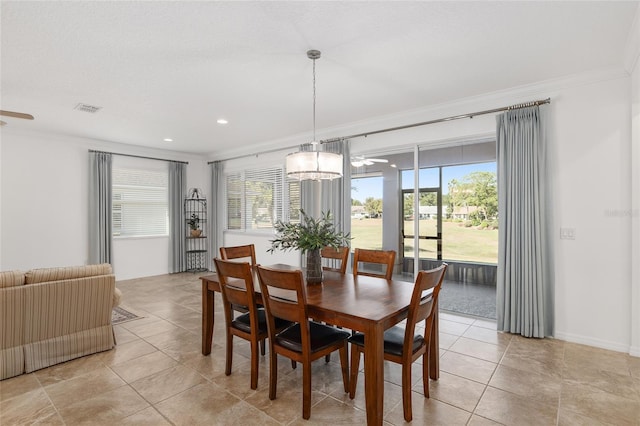 dining area featuring a chandelier, ornamental molding, and light tile patterned flooring