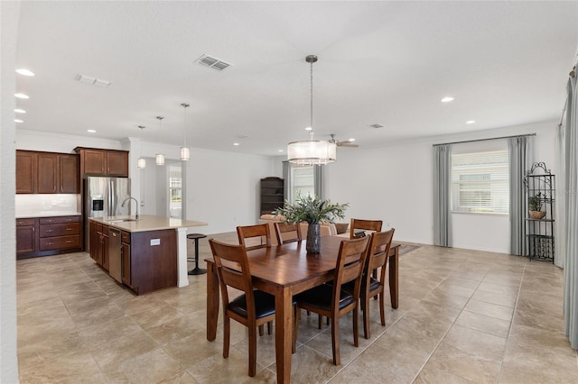 tiled dining area with ornamental molding and sink