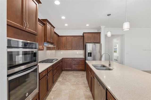 kitchen featuring light stone countertops, appliances with stainless steel finishes, ornamental molding, sink, and decorative light fixtures