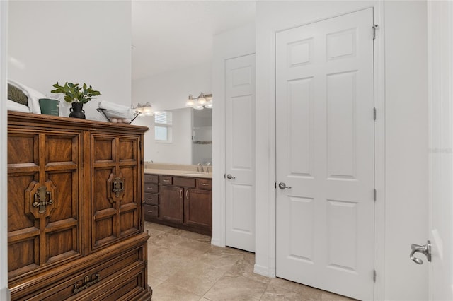 bathroom featuring tile patterned flooring and vanity