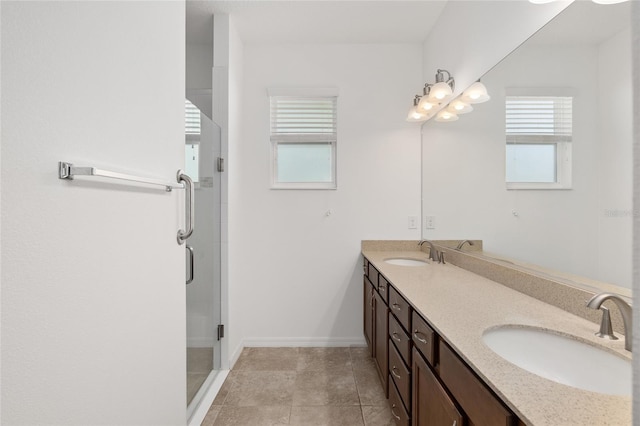 bathroom featuring tile patterned flooring, vanity, and walk in shower