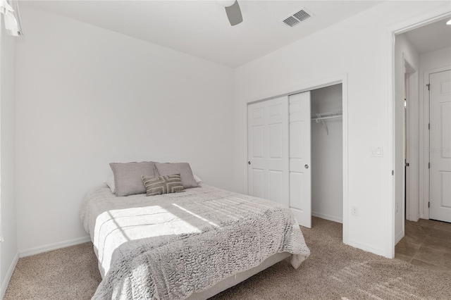 carpeted bedroom featuring ceiling fan and a closet