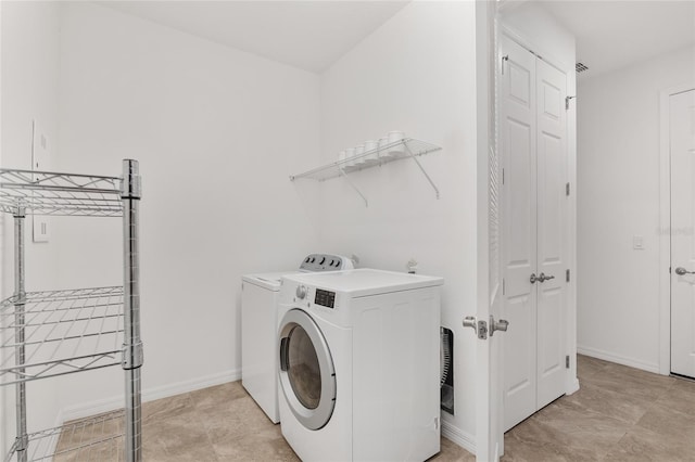 laundry area with washing machine and clothes dryer