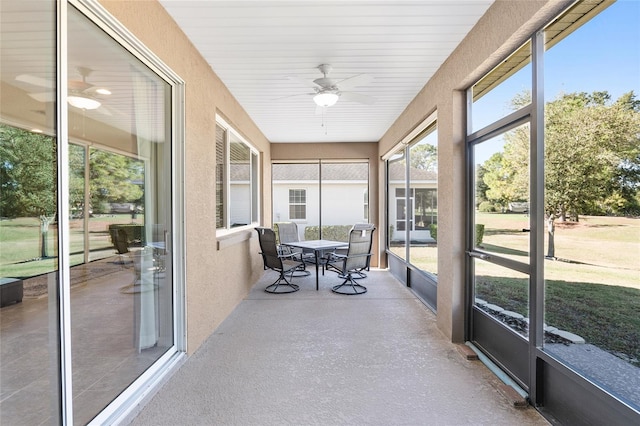 sunroom / solarium featuring ceiling fan