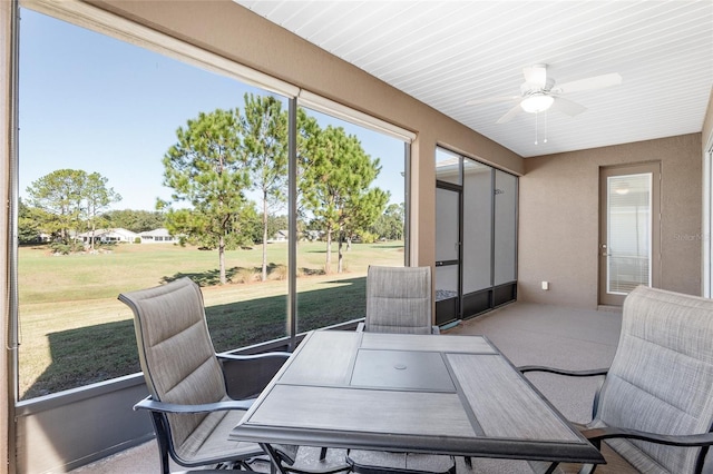 sunroom featuring ceiling fan