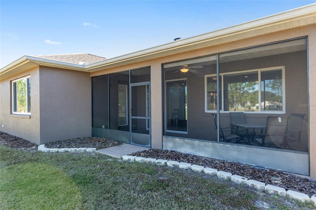 9350 SW 91st Court Rd, Ocala, FL 34481 - rear view of house with a sunroom, stucco siding, and a yard