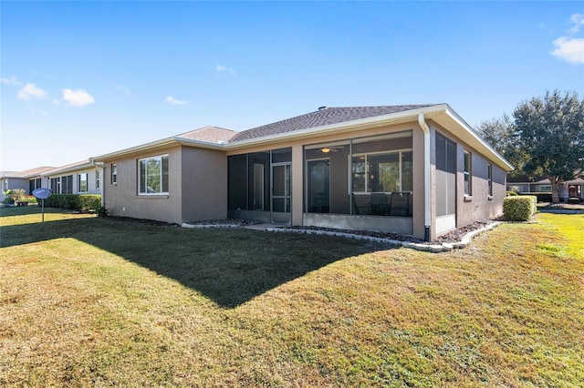 9350 SW 91st Court Rd, Ocala, FL 34481 - back of house featuring a sunroom, a lawn, and stucco siding
