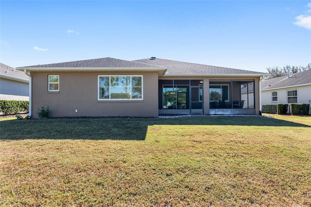 9350 SW 91st Court Rd, Ocala, FL 34481 - back of property featuring a sunroom, a lawn, and stucco siding
