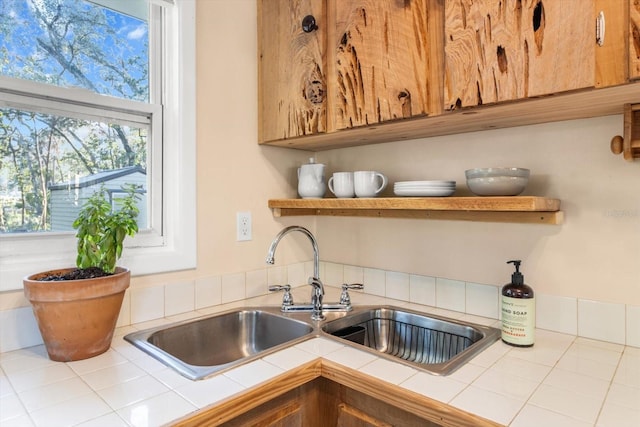 kitchen featuring tile countertops and sink