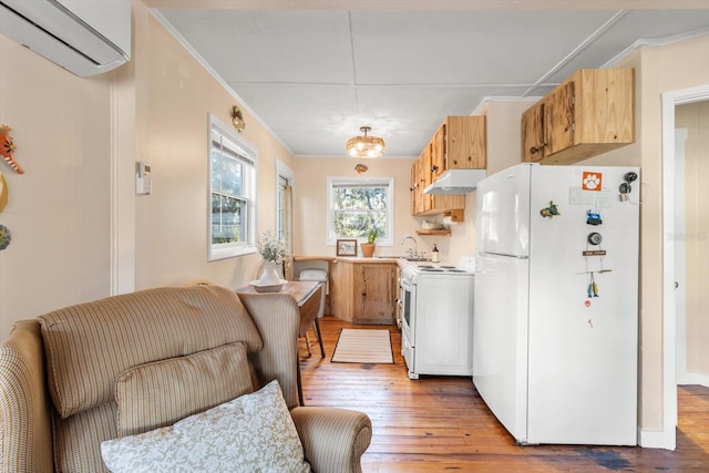 kitchen with light wood-type flooring, white appliances, a wall unit AC, and crown molding