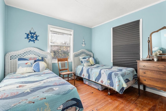 bedroom featuring hardwood / wood-style floors and ornamental molding