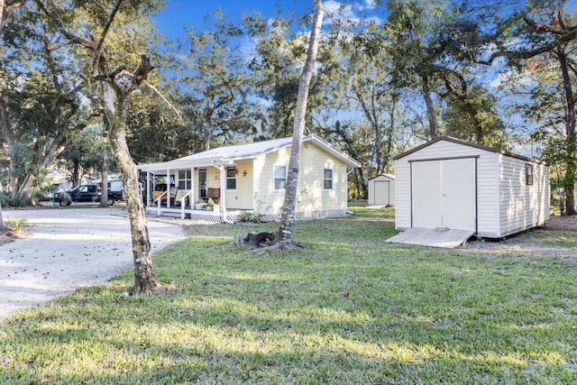 exterior space featuring a lawn, covered porch, and a shed