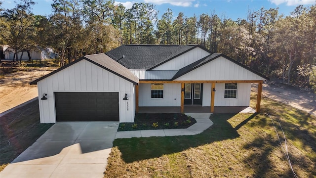 modern farmhouse style home with covered porch, a garage, and a front lawn