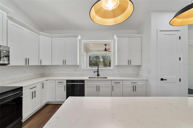 kitchen with stainless steel appliances, white cabinetry, dark wood-type flooring, and sink