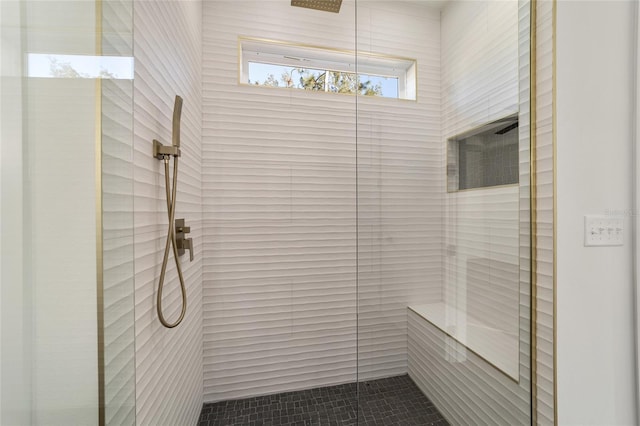 bathroom featuring a tile shower