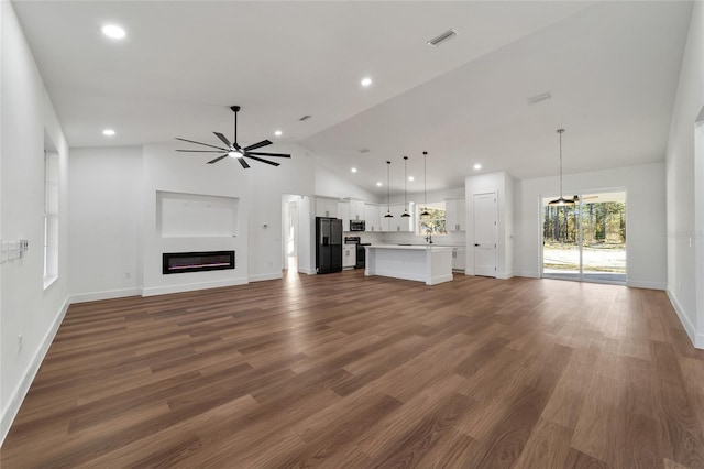 unfurnished living room featuring ceiling fan, dark wood-type flooring, and high vaulted ceiling