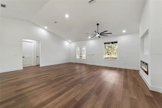 unfurnished living room with french doors, heating unit, ceiling fan, dark wood-type flooring, and lofted ceiling