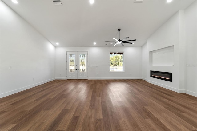 unfurnished living room featuring dark hardwood / wood-style floors, ceiling fan, and lofted ceiling