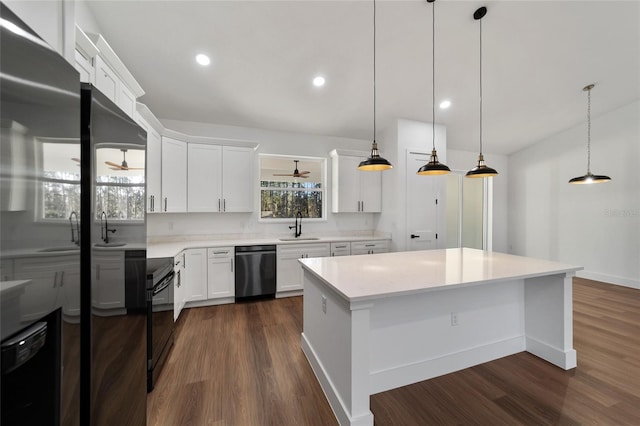 kitchen featuring dark hardwood / wood-style flooring, white cabinets, sink, decorative light fixtures, and dishwasher