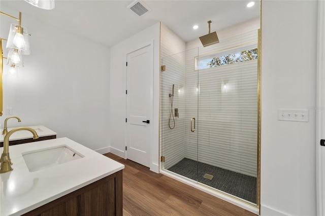 bathroom featuring vanity, hardwood / wood-style flooring, and walk in shower