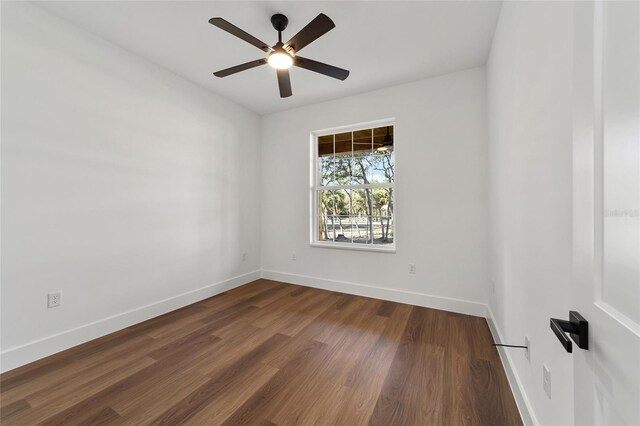 unfurnished room featuring dark hardwood / wood-style floors and ceiling fan