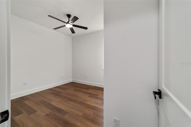 empty room with dark hardwood / wood-style floors and ceiling fan