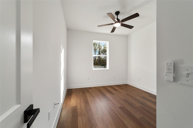 empty room featuring ceiling fan and dark wood-type flooring