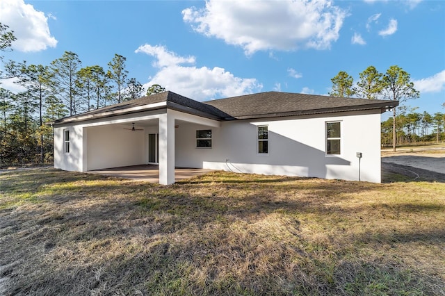 rear view of property with a lawn, ceiling fan, and a patio area