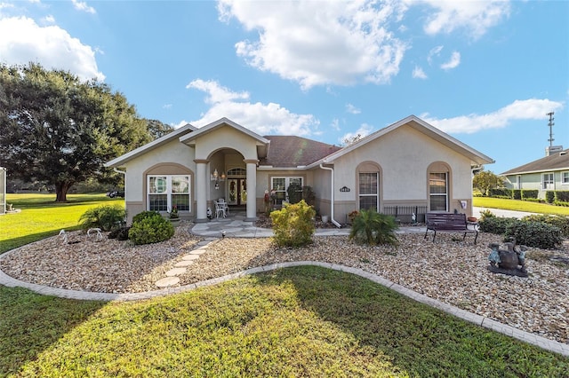 ranch-style home featuring a porch and a front lawn