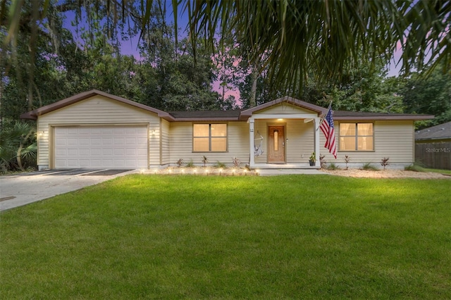 ranch-style home featuring a garage and a yard