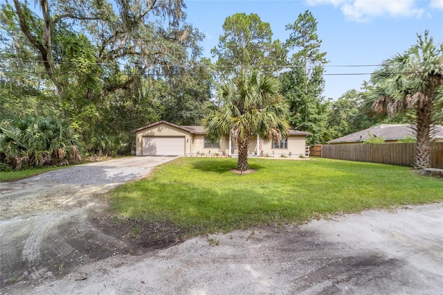 view of front of house with a garage and a front lawn