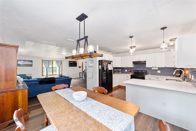 dining area with dark wood-type flooring and sink