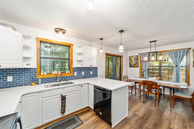 kitchen with white cabinets, light hardwood / wood-style floors, dishwasher, and sink