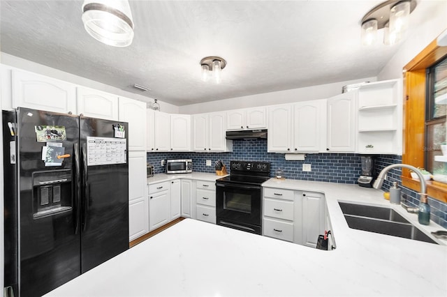 kitchen featuring black appliances, white cabinetry, sink, and tasteful backsplash