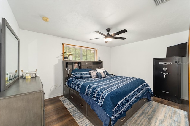 bedroom with dark hardwood / wood-style floors and ceiling fan