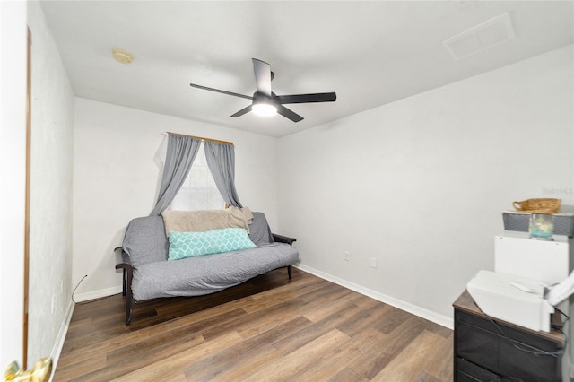 living area with dark hardwood / wood-style floors and ceiling fan