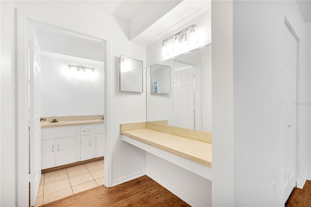 bathroom with hardwood / wood-style floors and vanity