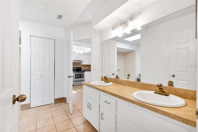 bathroom featuring vanity, a textured ceiling, and tile patterned floors