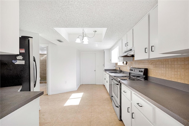 kitchen featuring hanging light fixtures, stainless steel appliances, a textured ceiling, a tray ceiling, and white cabinets