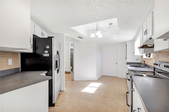 kitchen featuring pendant lighting, white cabinets, sink, a textured ceiling, and appliances with stainless steel finishes