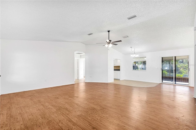 unfurnished living room with a textured ceiling, light hardwood / wood-style flooring, ceiling fan with notable chandelier, and vaulted ceiling