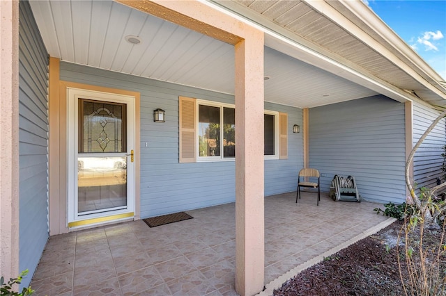 entrance to property featuring a porch