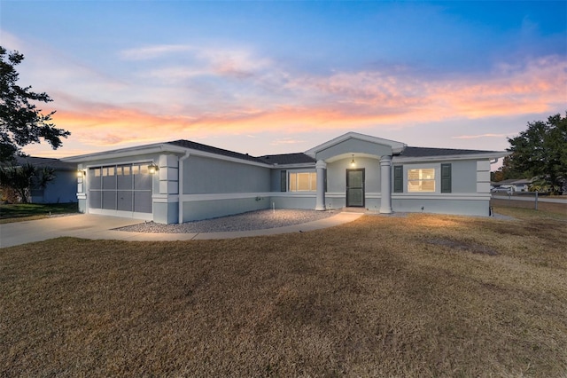 view of front of property with a yard and a garage